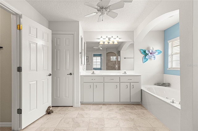 bathroom with ceiling fan, vanity, tile patterned flooring, and a textured ceiling