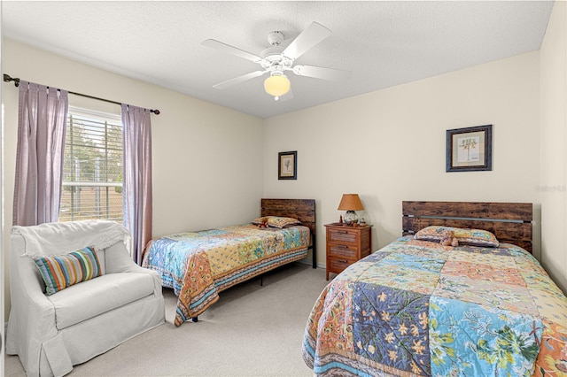 bedroom featuring ceiling fan, a textured ceiling, and carpet