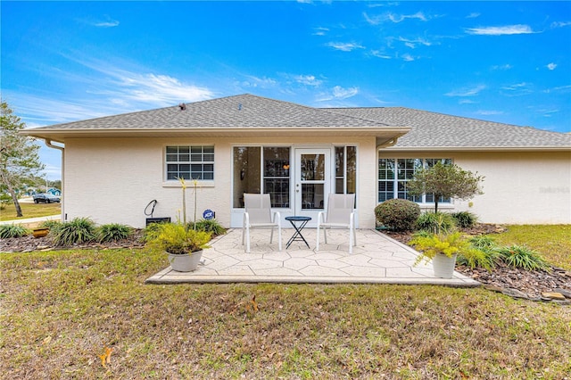 back of property featuring a yard and a patio area