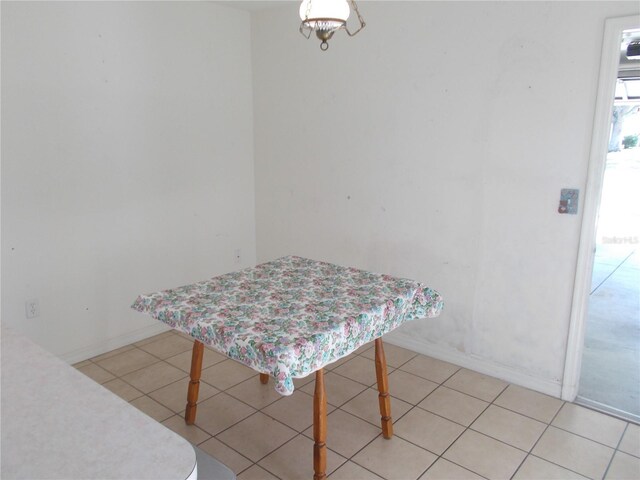 dining area with light tile patterned floors and baseboards