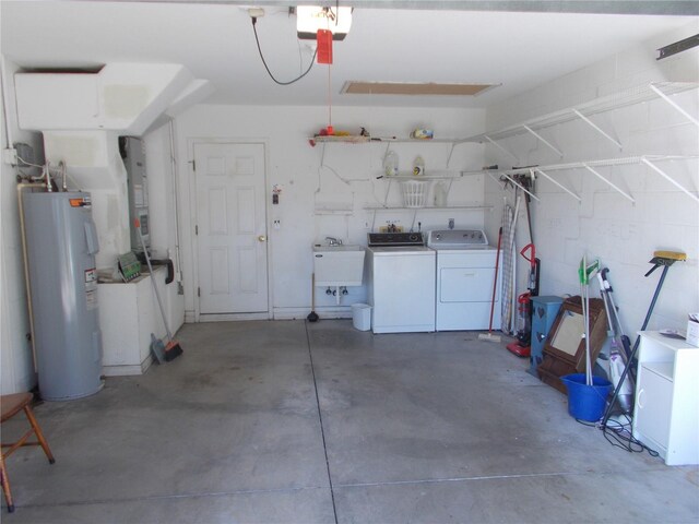 garage featuring heating unit, washing machine and dryer, a sink, electric water heater, and a garage door opener