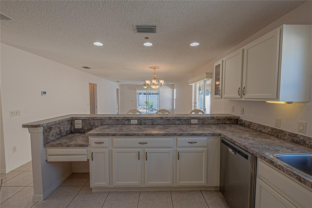 kitchen with white cabinetry, an inviting chandelier, hanging light fixtures, stainless steel dishwasher, and kitchen peninsula