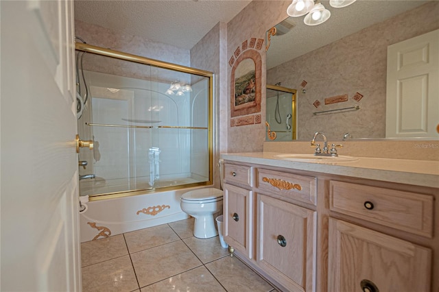 full bathroom with tile patterned floors, toilet, shower / bath combination with glass door, a textured ceiling, and vanity