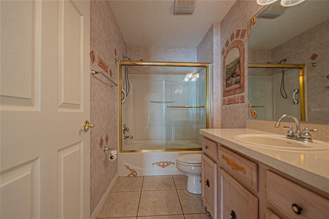 full bathroom with toilet, bath / shower combo with glass door, a textured ceiling, vanity, and tile patterned flooring