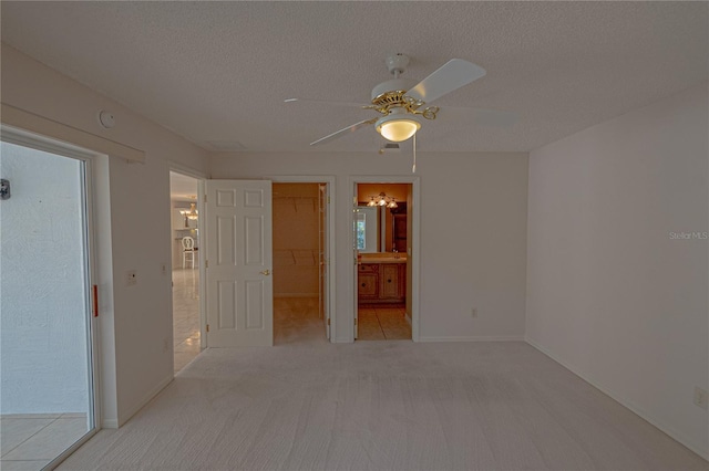 carpeted spare room with ceiling fan and a textured ceiling