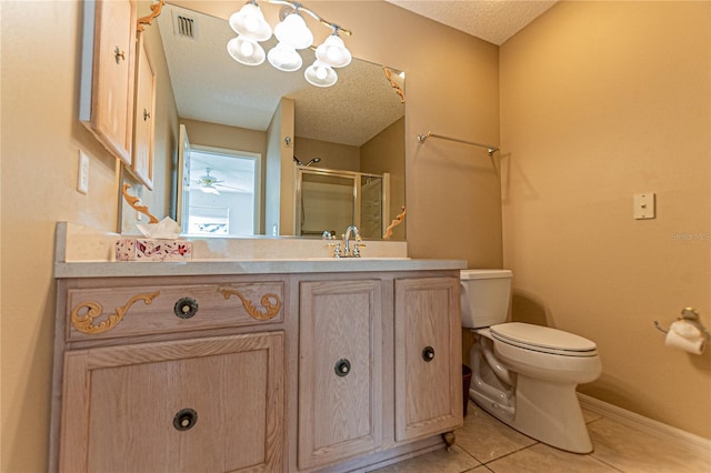 bathroom featuring vanity, toilet, a shower with shower door, and a textured ceiling