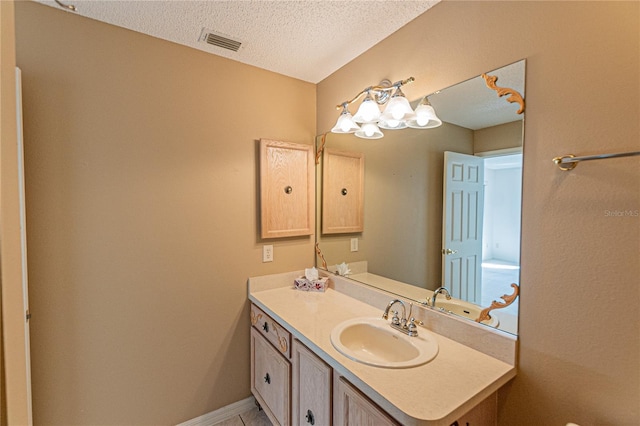 bathroom featuring vanity and a textured ceiling