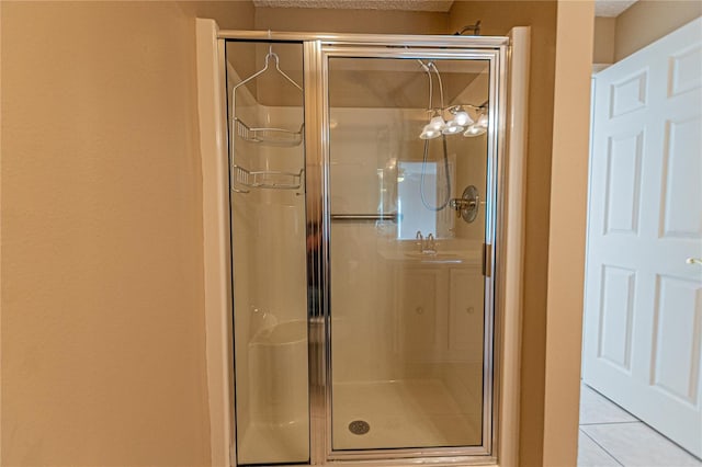 bathroom with tile patterned flooring, sink, and walk in shower