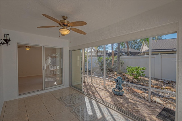 sunroom featuring ceiling fan