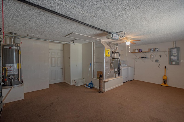 basement featuring washer and clothes dryer, electric panel, carpet, gas water heater, and a textured ceiling