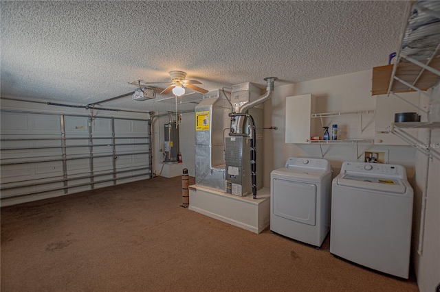 interior space featuring heating unit, independent washer and dryer, a garage door opener, and water heater