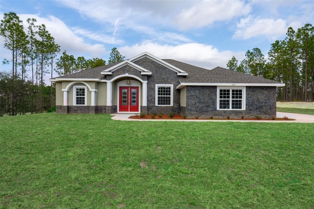 craftsman-style house featuring french doors and a front yard