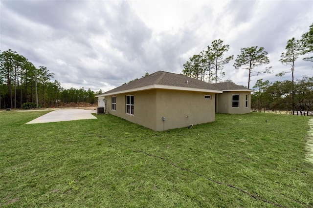 rear view of house with a patio and a yard