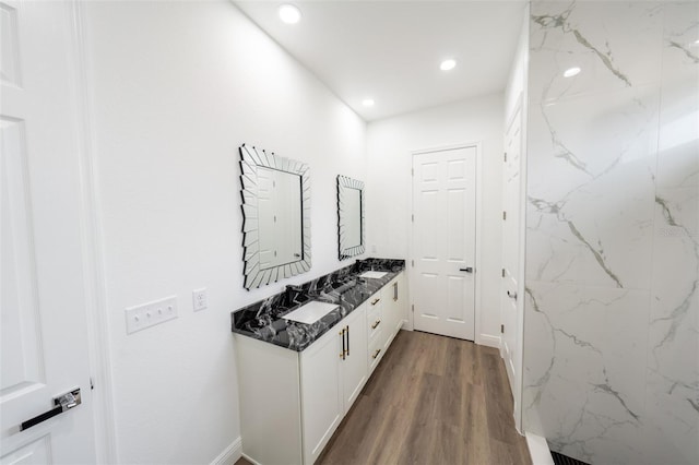 corridor featuring sink and hardwood / wood-style floors