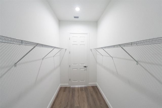 walk in closet featuring dark hardwood / wood-style floors