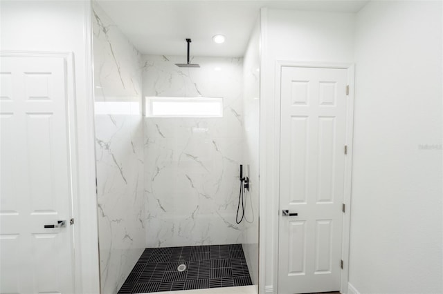 bathroom with a tile shower