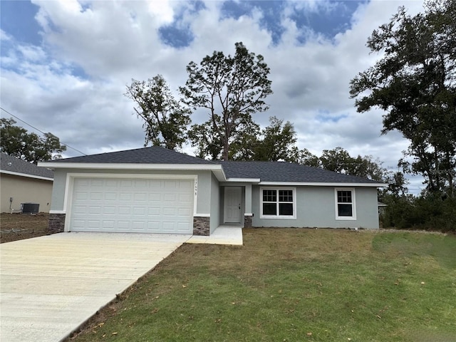 ranch-style house with cooling unit, a garage, and a front lawn