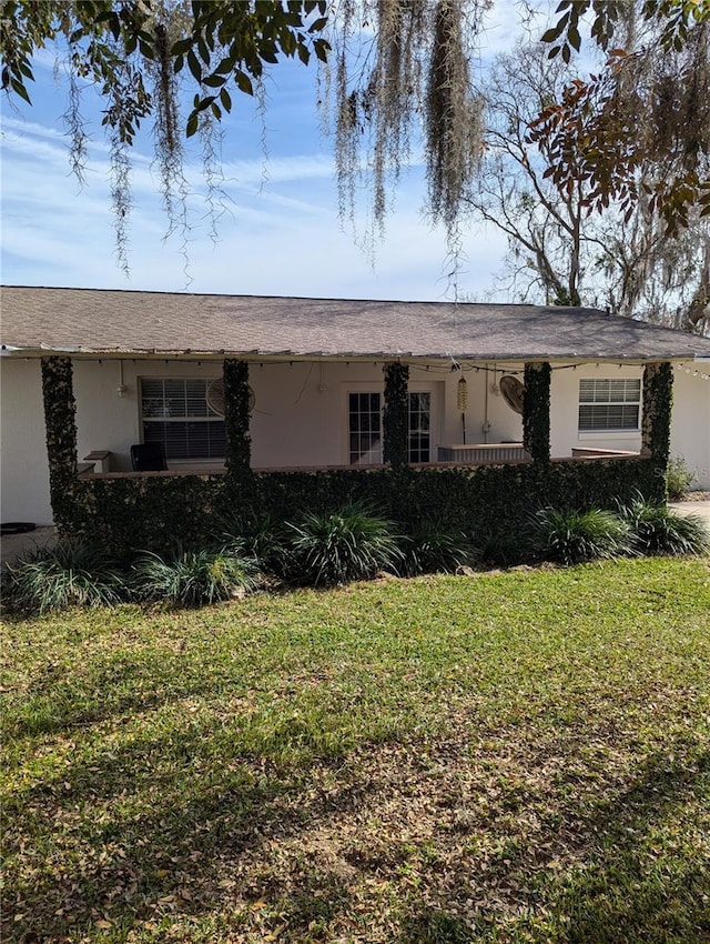 view of front of house featuring a front lawn and stucco siding