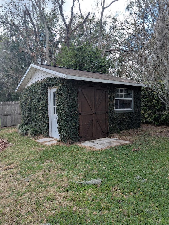 view of shed featuring fence