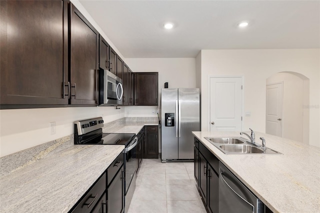 13818 NW 9th Rd, Newberry, FL 32669 - kitchen with sink, appliances with stainless steel finishes, dark brown cabinetry, light stone counters, and light tile patterned flooring
