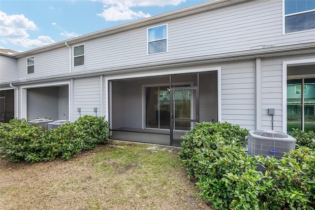 13818 NW 9th Rd, Newberry, FL 32669 - back of house featuring a yard, central AC unit, and a sunroom