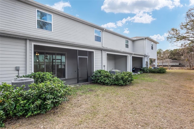 13818 NW 9th Rd, Newberry, FL 32669 - rear view of property featuring a lawn and central air condition unit