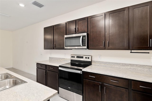 13818 NW 9th Rd, Newberry, FL 32669 - kitchen with dark brown cabinetry, appliances with stainless steel finishes, and sink