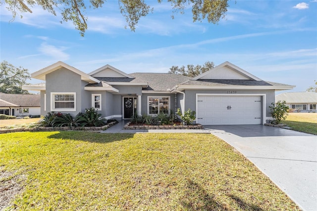 ranch-style house featuring a garage and a front lawn