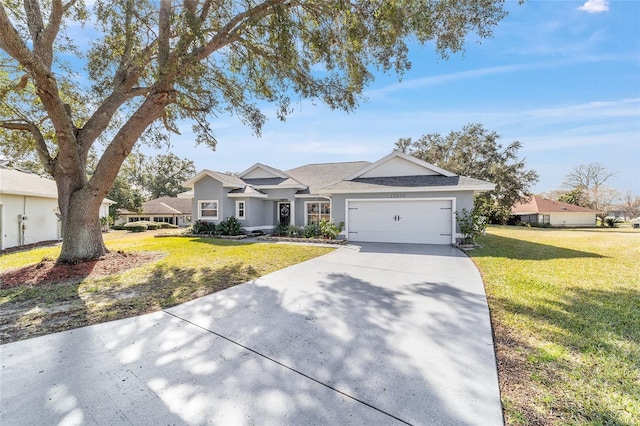 ranch-style home with a garage and a front lawn