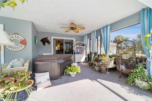 interior space with ceiling fan