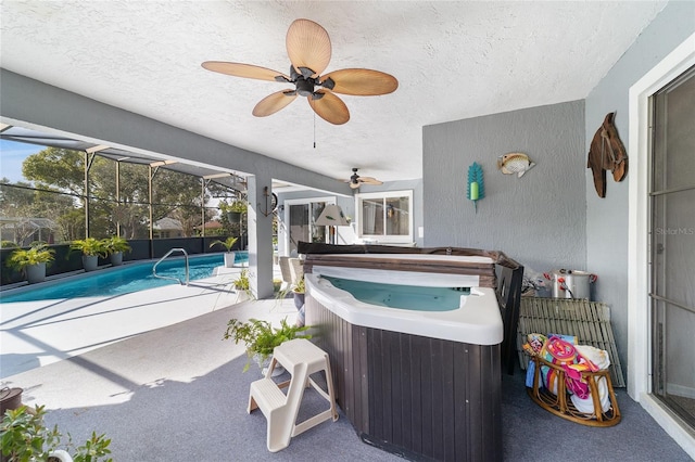 view of swimming pool with a lanai, a patio area, a hot tub, and ceiling fan