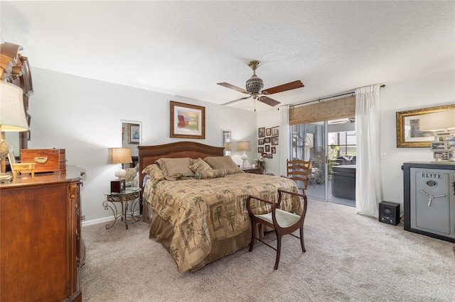 carpeted bedroom featuring access to exterior, a textured ceiling, and ceiling fan