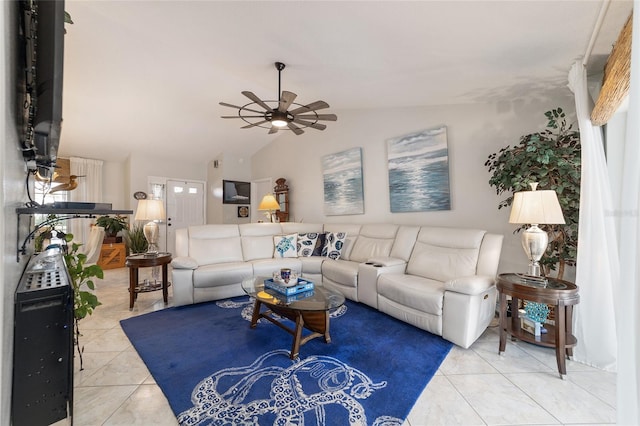 living room featuring ceiling fan, vaulted ceiling, and light tile patterned floors