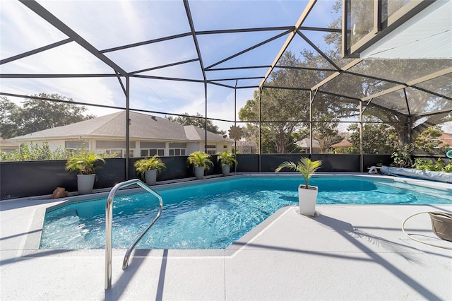 view of swimming pool featuring a lanai and a patio