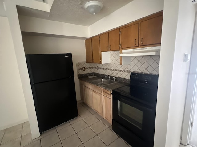 kitchen featuring sink, light tile patterned floors, backsplash, black appliances, and a textured ceiling