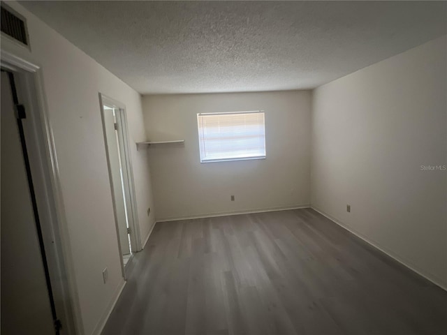 unfurnished bedroom featuring light hardwood / wood-style floors and a textured ceiling