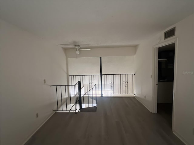 hallway with hardwood / wood-style flooring