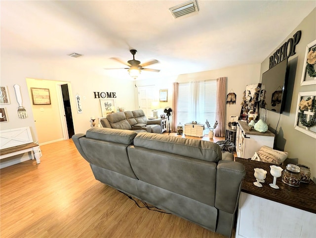 living room featuring light hardwood / wood-style floors and ceiling fan