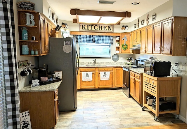 kitchen with light stone counters, sink, and stainless steel electric range