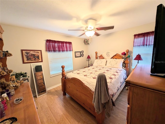 bedroom featuring light hardwood / wood-style floors and ceiling fan