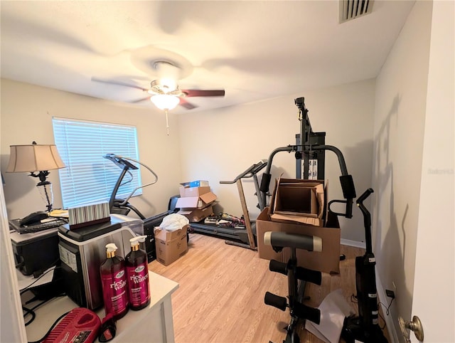 exercise room featuring ceiling fan and light wood-type flooring