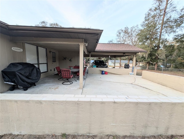 view of patio / terrace with a grill and a carport