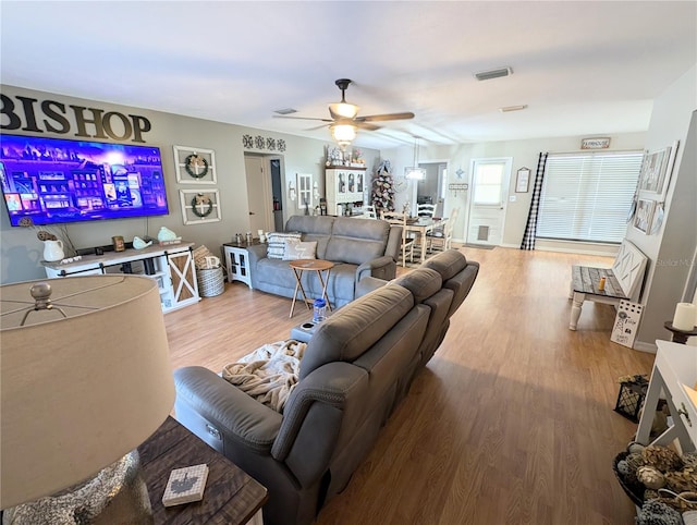 living room with wood-type flooring and ceiling fan