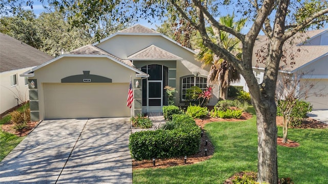 view of front of home featuring a garage and a front lawn