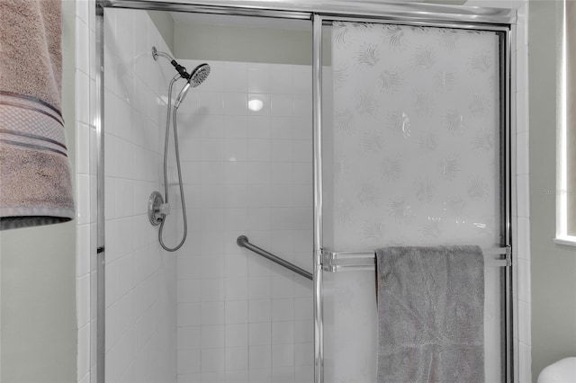 bathroom with a shower with door