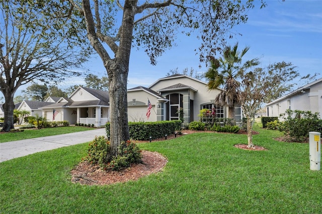 view of front of property with a garage and a front lawn