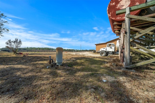 view of yard with a rural view