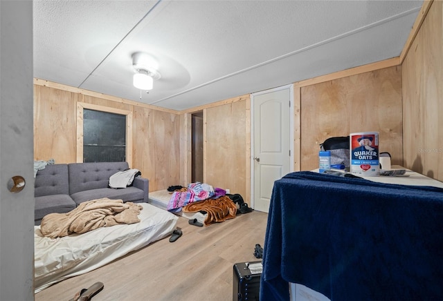 bedroom with wooden walls and wood finished floors