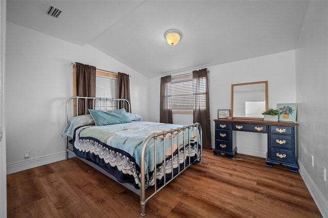 bedroom featuring vaulted ceiling, dark wood finished floors, visible vents, and baseboards