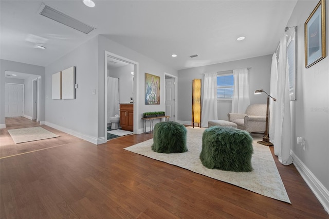 bedroom featuring ensuite bathroom, recessed lighting, wood finished floors, visible vents, and baseboards